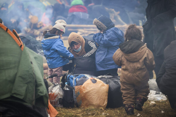 Migrants from the Middle East and elsewhere camp at the checkpoint "Kuznitsa" at the Belarus-Poland border near Grodno, Belarus, on Wednesday, Nov. 17, 2021. Some of the migrants have children with them at the border in their desperate bid to reach the EU. Most are fleeing conflict, poverty and instability in the Middle East and elsewhere. (Leonid Shcheglov/BelTA via AP)