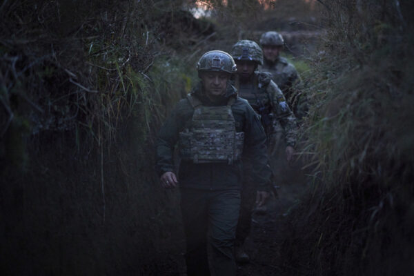 FILE – Ukrainian President Volodymyr Zelenskyy surrounded by servicemen as he visits the war-hit Donetsk region, eastern Ukraine, on Oct. 14, 2021. Ukrainian and Western officials are worried that a Russian military buildup near Ukraine could signal plans by Moscow to invade its ex-Soviet neighbor. The Kremlin insists it has no such intention and has accused Ukraine and its Western backers of making the claims to cover up their own allegedly aggressive designs. (Ukrainian Presidential Press Office via AP, File)