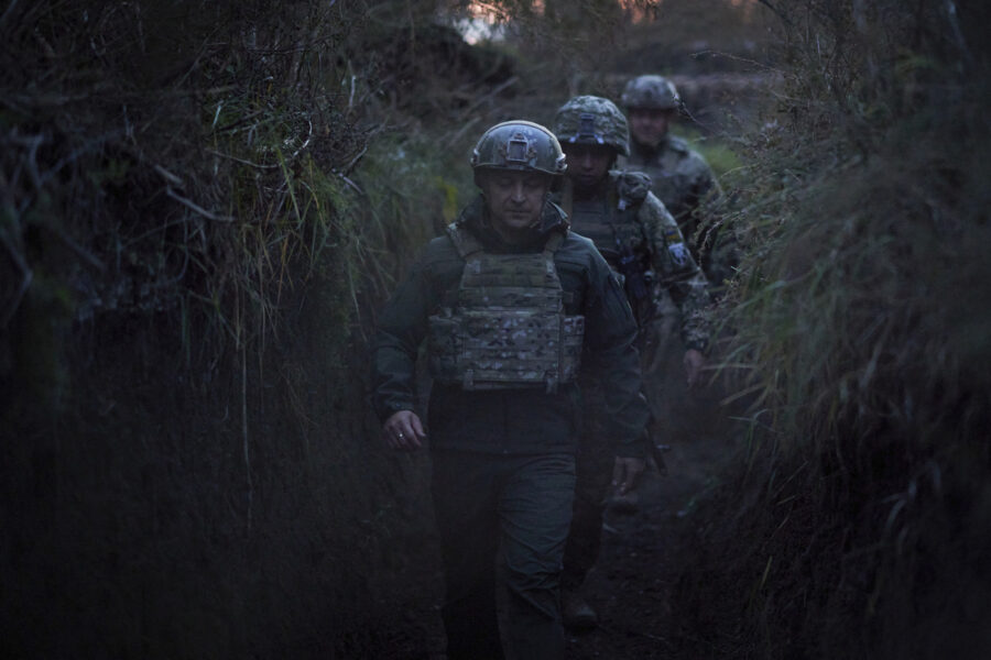 FILE – Ukrainian President Volodymyr Zelenskyy surrounded by servicemen as he visits the war-hit Donetsk region, eastern Ukraine, on Oct. 14, 2021. Ukrainian and Western officials are worried that a Russian military buildup near Ukraine could signal plans by Moscow to invade its ex-Soviet neighbor. The Kremlin insists it has no such intention and has accused Ukraine and its Western backers of making the claims to cover up their own allegedly aggressive designs. (Ukrainian Presidential Press Office via AP, File)