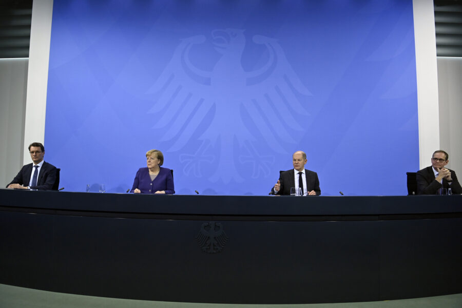 From left; Hendrick Wuest, Minister of North Rhine-Westphalia, German Chancellor Angela Merkel, German Finance Minister Olaf Scholz and Governing Mayor of Berlin Michael Mueller give a press conference following a meeting with the heads of government of Germany’s federal states at the Chancellery in Berlin, Thursday, Dec. 2, 2021. Merkel said Thursday that people who aren’t vaccinated will be excluded from nonessential stores, cultural and recreational venues, and parliament will consider a general vaccine mandate, as part of an effort to curb coronavirus infections that again topped 70,000 newly confirmed cases in a 24-hour period. (John Macdougall/Pool Photo via AP)