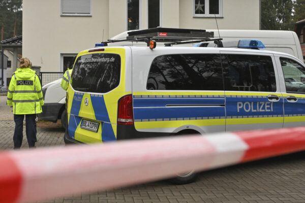 Police have cordoned off a single-family home in Senzig, a district of the town of Kownigs Wusterhausen in the Dahme-Spreewald district, Saturday, Dec.4, 2021. Police found five dead bodies in a home there. The police assume a homicide, a spokesman said. (Patrick Pleul/dpa via AP)