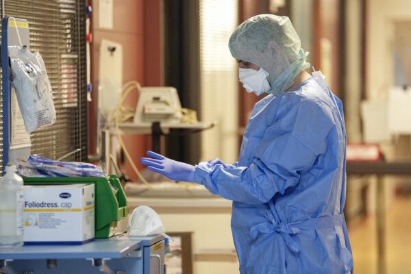 ICU nurse Stefan gets ready before entering an isolation room with an intubated COVID-19 patient at the intensive care unit at the Westerstede Clinical Center, a military-civilian hospital in Westerstede, northwest Germany, Friday, Dec. 17, 2021. (AP Photo/Martin Meissner) ICU nurse Stefan gets ready before entering an isolation room with an intubated COVID-19 patient at the intensive care unit at the Westerstede Clinical Center, a military-civilian hospital in Westerstede, northwest Germany, Friday, Dec. 17, 2021. (AP Photo/Martin Meissner)
