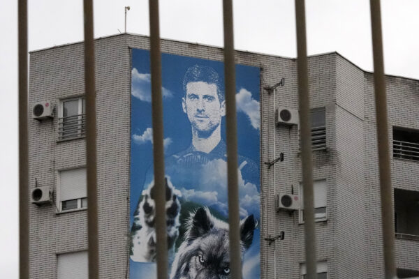 A billboard depicting Serbian tennis player Novak Djokovic hangs on a building in Belgrade, Serbia, Thursday, Jan. 6, 2022. The Australian government has denied No. 1-ranked Djokovic entry to defend his title in the year’s first tennis major and canceled his visa because he failed to meet the requirements for an exemption to the country’s COVID-19 vaccination rules. (AP Photo/Darko Vojinovic)