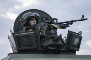 A Ukrainian National guard soldier guards a mobile checkpoint together with the Ukrainian Security Service agents and police officers during a joint operation, in Kharkiv, Ukraine, Thursday, Feb. 17, 2022. Fears of a new war in Europe have resurged as U.S. President Joe Biden warned that Russia could invade Ukraine within days, and violence spiked in a long-running standoff in eastern Ukraine that some fear could be the spark for wider conflict. (AP Photo/Evgeniy Maloletka)