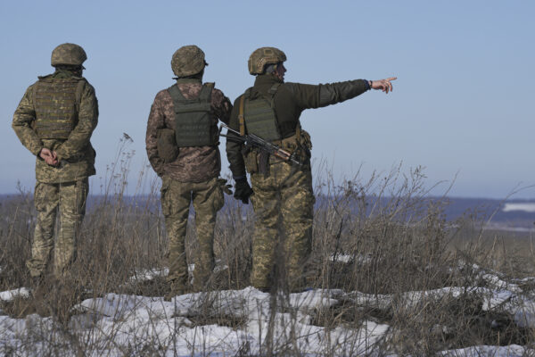 Ukrainian servicemen survey the impact areas from shells that landed close to their positions during the night on a front line outside Popasna, Luhansk region, eastern Ukraine, Monday, Feb. 14, 2022. Russia’s Foreign Minister Sergey Lavrov advised President Vladimir Putin on Monday to keep talking with the West on Moscow’s security demands, a signal from the Kremlin that it intends to continue diplomatic efforts amid U.S. warnings of an imminent Russian invasion of Ukraine.(AP Photo/Vadim Ghirda)