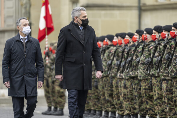 Swiss Federal President Ignazio Cassis, left, and his guest Karl Nehammer, Chancellor of Austria, inspect the guard of honour of the Swiss Army during an official visit, in Zofingen, Switzerland, on Monday, Feb. 14, 2022. (Alessandro della Valle/Keystone via AP)