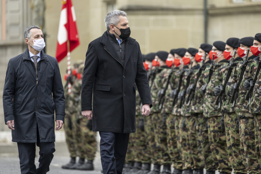 Swiss Federal President Ignazio Cassis, left, and his guest Karl Nehammer, Chancellor of Austria, inspect the guard of honour of the Swiss Army during an official visit, in Zofingen, Switzerland, on Monday, Feb. 14, 2022. (Alessandro della Valle/Keystone via AP)