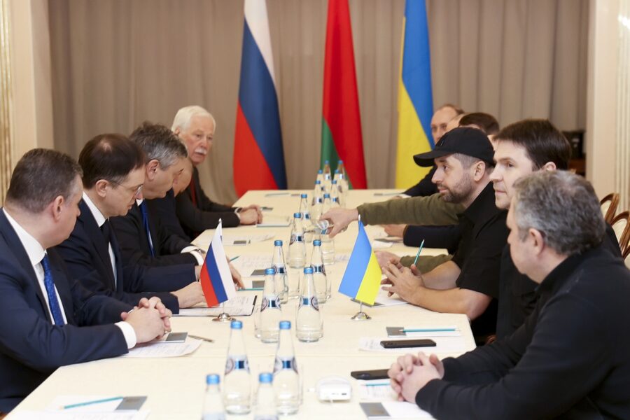 Vladimir Medinsky, the head of the Russian delegation, second left, and Davyd Arakhamia, faction leader of the Servant of the People party in the Ukrainian Parliament, third right, attend the peace talks in the Gomel region, Belarus, Monday, Feb. 28, 2022. The Russian and Ukrainian delegations have met for their first talks today. The meeting is taking place in Gomel region on the banks of the Pripyat River, BelTA has learned. (Sergei Kholodilin/BelTA Pool Photo via AP)