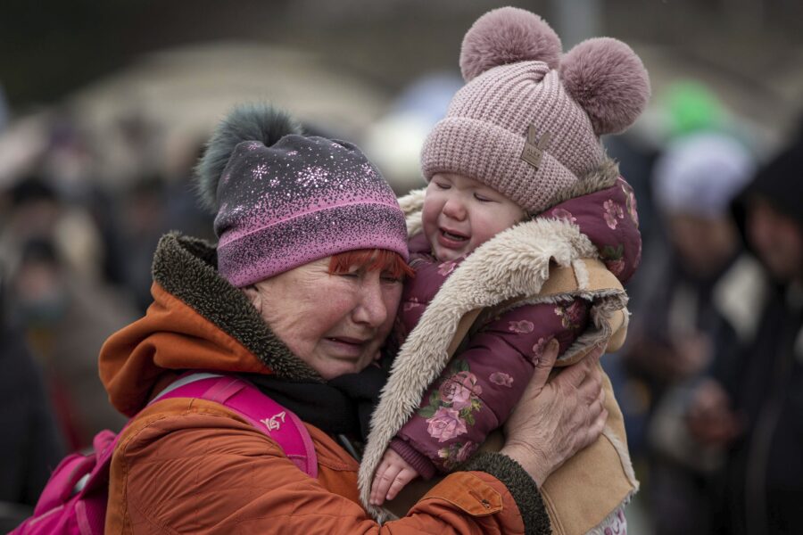 A woman holding a child cries after fleeing from the Ukraine and arriving at the border crossing in Medyka, Poland, Monday, March 7, 2022. Russia announced yet another cease-fire and a handful of humanitarian corridors to allow civilians to flee Ukraine. Previous such measures have fallen apart and Moscow’s armed forces continued to pummel some Ukrainian cities with rockets Monday. (AP Photo/Visar Kryeziu)