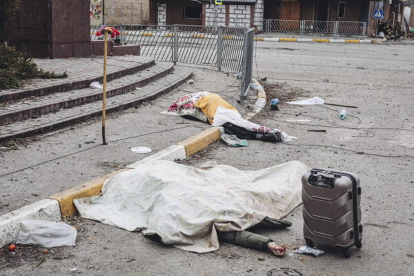 The dead bodies of people killed by Russian shelling lay covered in the street in the town of Irpin, Ukraine, Sunday, March 6, 2022. With the Kremlin’s rhetoric growing fiercer and a reprieve from fighting dissolving, Russian troops continued to shell encircled cities and the number of Ukrainians forced from their country grew to over 1.4 million. (AP Photo/Diego Herrera Carcedo) The dead bodies of people killed by Russian shelling lay covered in the street in the town of Irpin, Ukraine, Sunday, March 6, 2022. With the Kremlin’s rhetoric growing fiercer and a reprieve from fighting dissolving, Russian troops continued to shell encircled cities and the number of Ukrainians forced from their country grew to over 1.4 million. (AP Photo/Diego Herrera Carcedo)