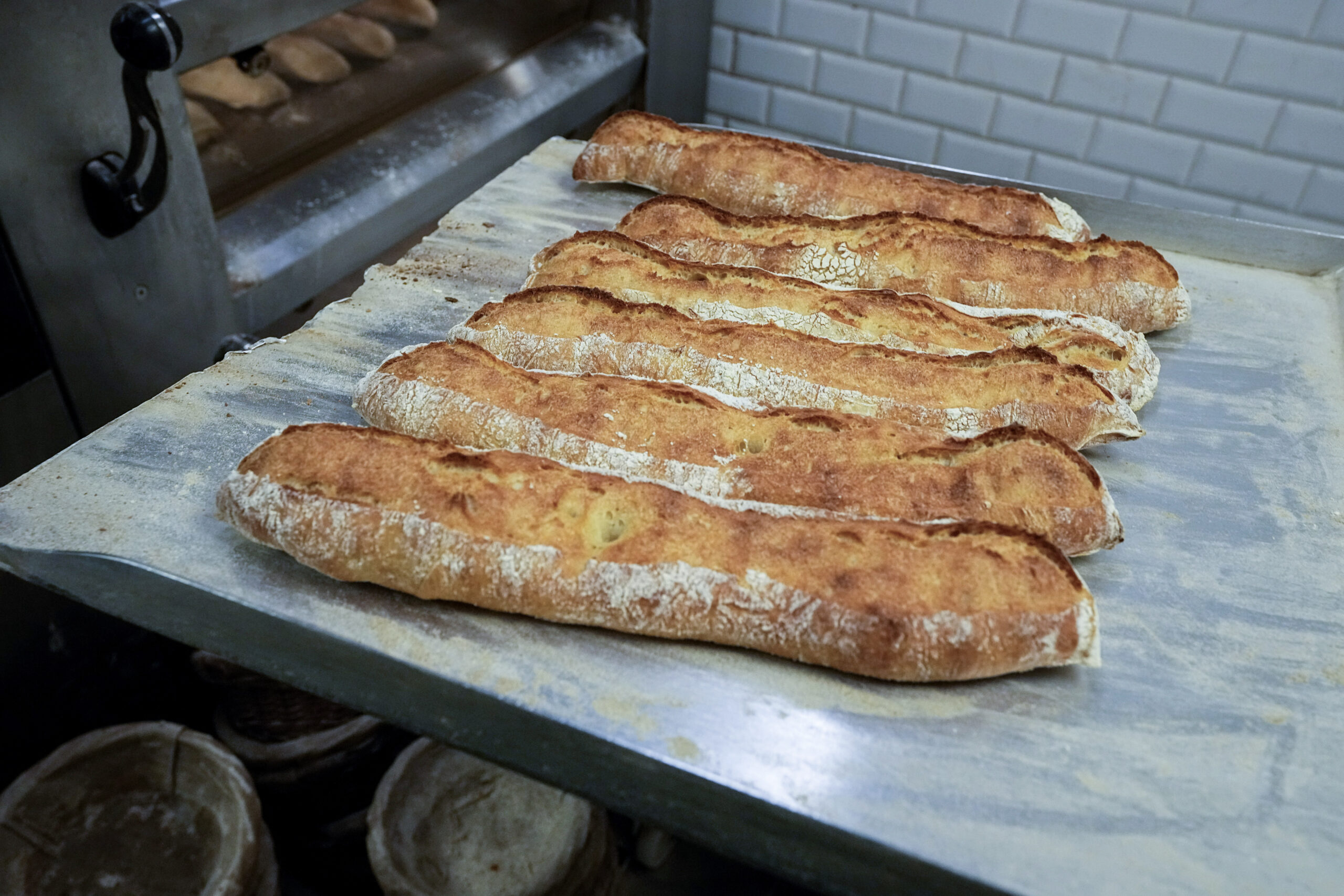 Baguettes are removed from the oven at Feru bakery in Louveciennes, west of Paris, Tuesday, Oct. 26, 2021. A worldwide increase in wheat prices after bad harvests in Russia is forcing French bakers to raise the price of that staple of life in France the baguette. Boulangeries around France have begun putting up signs warning their customers of an increase in the price of their favorite bread due to rising costs. (AP Photo/Michel Euler Baguettes are removed from the oven at Feru bakery in Louveciennes, west of Paris, Tuesday, Oct. 26, 2021. A worldwide increase in wheat prices after bad harvests in Russia is forcing French bakers to raise the price of that staple of life in France the baguette. Boulangeries around France have begun putting up signs warning their customers of an increase in the price of their favorite bread due to rising costs. (AP Photo/Michel Euler