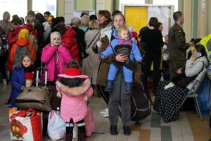 Ukrainian Marina Stadnik from Kramatosrk, waits with her four children at a train station in Przemysl, southeastern Poland, Monday, March 28, 2022. The more than month-old war has killed thousands and driven more than 10 million Ukrainians from their homes — including almost 4 million from their country. (AP Photo/Sergei Grits)
Ukrainian Marina Stadnik from Kramatosrk, waits with her four children at a train station in Przemysl, southeastern Poland, Monday, March 28, 2022. The more than month-old war has killed thousands and driven more than 10 million Ukrainians from their homes — including almost 4 million from their country. (AP Photo/Sergei Grits)