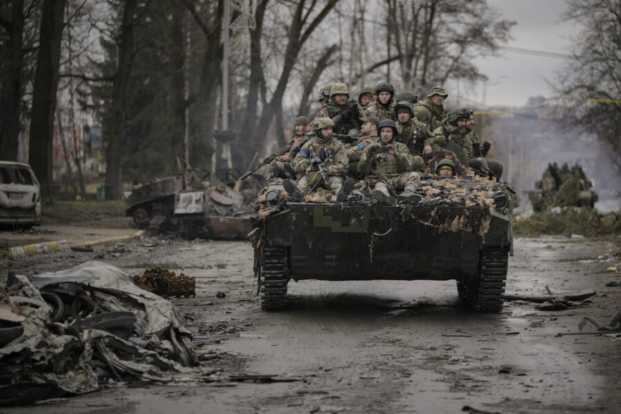 FILE – Ukrainian servicemen ride on a fighting vehicle outside Kyiv, Ukraine, April 2, 2022. Kyiv was a Russian defeat for the ages. It started poorly for the invaders and went downhill from there. (AP Photo/Vadim Ghirda, File)