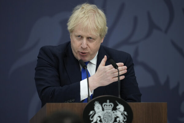 British Prime Minister Boris Johnson delivers a speech at Lydd Airport, south east England, Thursday, April 14, 2022. Britain says it has struck a deal with Rwanda to send some asylum-seekers to the central African country, a proposal that has been condemned by opposition politicians and refugee groups. (AP Photo/Matt Dunham, Pool) British Prime Minister Boris Johnson delivers a speech at Lydd Airport, south east England, Thursday, April 14, 2022. Britain says it has struck a deal with Rwanda to send some asylum-seekers to the central African country, a proposal that has been condemned by opposition politicians and refugee groups. (AP Photo/Matt Dunham, Pool)