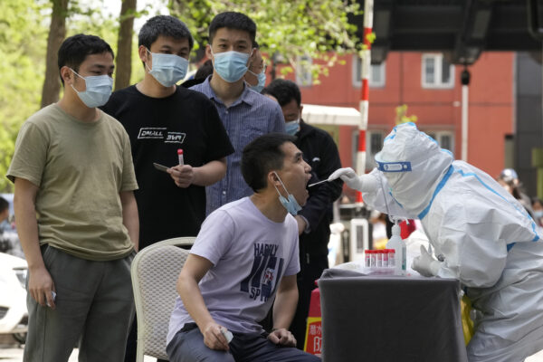 Residents line up for COVID testing outside a hotel in the Haidian district on Tuesday, April 26, 2022, in Beijing. China’s capital Beijing is enforcing mass testing and closing down access to neighborhoods as it seeks to contain a new COVID-19 outbreak. (AP Photo/Ng Han Guan)