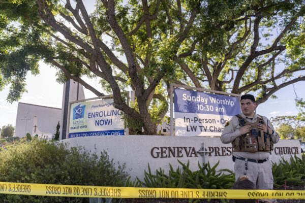 An Orange County Sheriff’s Department officer guards the grounds at Geneva Presbyterian Church in Laguna Woods, Calif., Sunday, May 15, 2022, after a fatal shooting. (AP Photo/Damian Dovarganes)