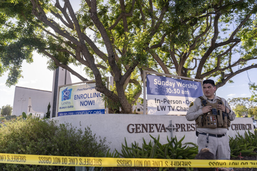 An Orange County Sheriff’s Department officer guards the grounds at Geneva Presbyterian Church in Laguna Woods, Calif., Sunday, May 15, 2022, after a fatal shooting. (AP Photo/Damian Dovarganes)