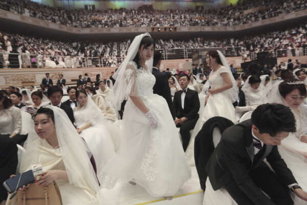 A bride arrives to attend a mass wedding ceremony at the Cheong Shim Peace World Center in Gapyeong, South Korea, Friday, Feb. 7, 2020. South Korean and foreign couples exchanged or reaffirmed marriage vows in the Unification Church’s mass wedding arranged by Hak Ja Han Moon, wife of the late Rev. Sun Myung Moon, the controversial founder of the Unification Church. (AP Photo/Ahn Young-joon)