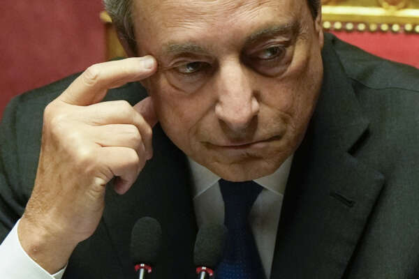 Italian Premier Mario Draghi waits to deliver his speech at the Senate in Rome, Wednesday, July 20, 2022. Draghi was deciding Wednesday whether to confirm his resignation or reconsider appeals to rebuild his parliamentary majority after the populist 5-Star Movement triggered a crisis in the government by withholding its support. (AP Photo/Andrew Medichini)