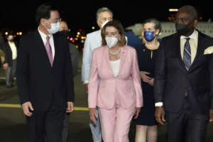 In this photo released by the Taiwan Ministry of Foreign Affairs, U.S. House Speaker Nancy Pelosi, center, walks with Taiwan’s Foreign Minister Joseph Wu, left, as she arrives in Taipei, Taiwan, Tuesday, Aug. 2, 2022. Pelosi arrived in Taiwan on Tuesday night despite threats from Beijing of serious consequences, becoming the highest-ranking American official to visit the self-ruled island claimed by China in 25 years. ( Taiwan Ministry of Foreign Affairs via AP)