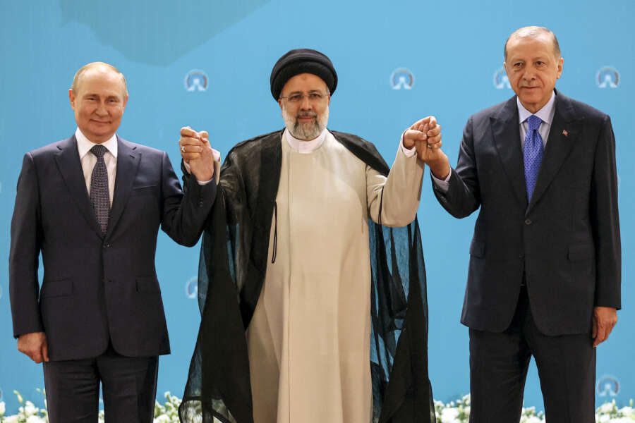 Russian President Vladimir Putin, left, Iranian President Ebrahim Raisi, center, and Turkish President Recep Tayyip Erdogan pose for a photo prior to their talks at the Saadabad palace, in Tehran, Iran, Tuesday, July 19, 2022. (Sergei Savostyanov, Sputnik, Kremlin Pool Photo via AP)