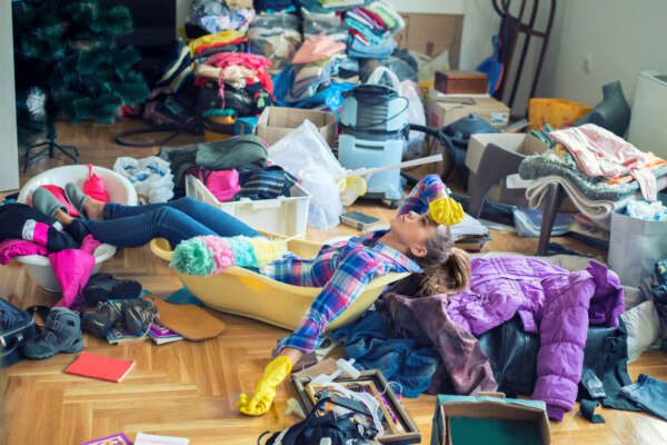 Housewife frustrated by cleaning mess at home.