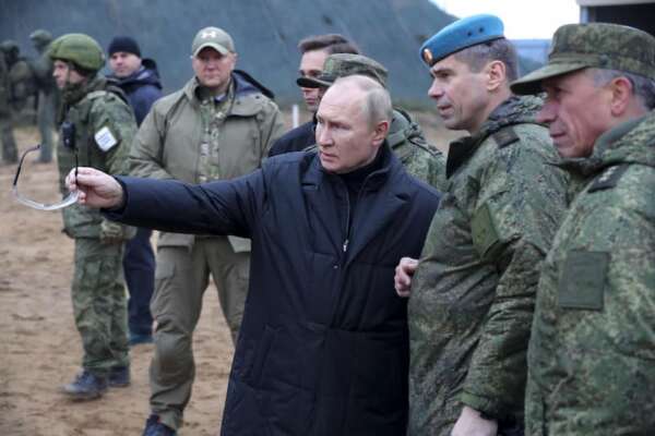 Russian President Vladimir Putin, center, gestures as he visits a military training centre of the Western Military District for mobilised reservists in Ryazan Region, Russia, Thursday, Oct. 20, 2022. Deputy Commander of the Airborne Troops Anatoly Kontsevoy stands right of Putin. (Mikhail Klimentyev, Sputnik, Kremlin Pool Photo via AP)