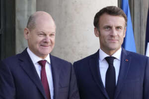 FILE – French President Emmanuel Macron, right, welcomes German Chancellor Olaf Scholz at the Elysee Palace in Paris, Oct. 26, 2022. France and Germany are seeking to overcome differences laid bare by the Ukraine war and shore up their alliance with a day of ceremonies and talks Sunday, Jan. 22, 2023 on Europe’s security, energy and other challenges. (AP Photo/Christophe Ena, File)