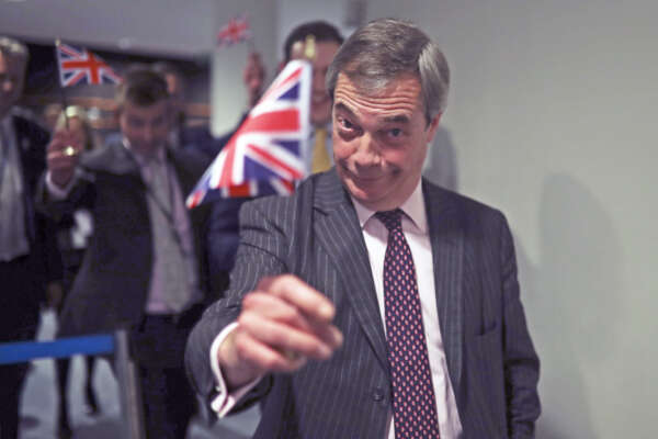 British European Parliament member Nigel Farage leaves the hemicycle after addressing European lawmakers during the plenary session at the European Parliament in Brussels, Wednesday, Jan. 29, 2020. The U.K. is due to leave the EU on Friday, Jan. 31, 2020, the first nation in the bloc to do so. (AP Photo/Francisco Seco)