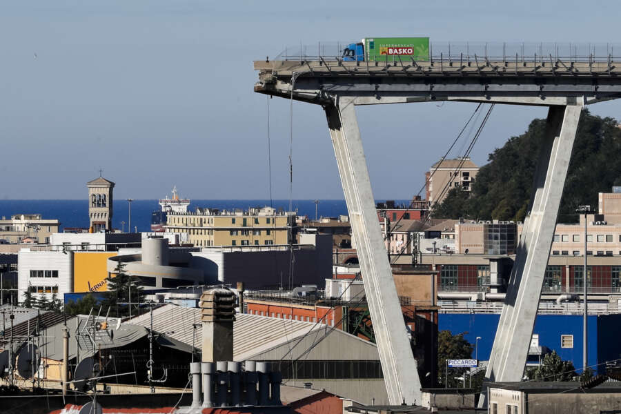 FILE – A Wednesday, Aug. 15, 2018 file photo showing a view of the Morandi highway bridge that collapsed in Genoa, northern Italy. Fifty-nine people went on trial Thursday, July 7, 2022, for the 2018 collapse of Genoa’s Morandi bridge, accused of manslaughter and other charges in the deaths of 43 people. (AP Photo/Antonio Calanni, File)