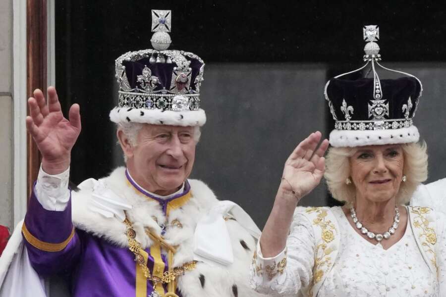 Britain’s King Charles III and Queen Camilla wave to the crowds from the balcony of Buckingham Palace after the coronation ceremony in London, Saturday, May 6, 2023. (AP Photo/Frank Augstein)