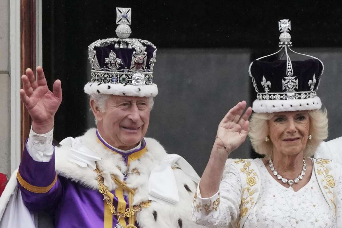 Britain’s King Charles III and Queen Camilla wave to the crowds from the balcony of Buckingham Palace after the coronation ceremony in London, Saturday, May 6, 2023. (AP Photo/Frank Augstein)