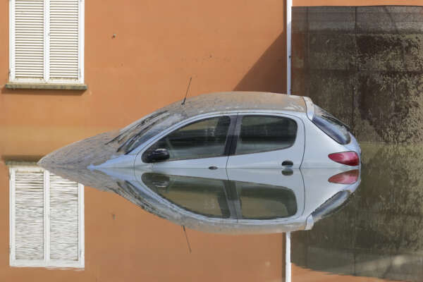 A car is submerged in Faenza, Italy, on May 18, 2023. A rare, triple-whammy of cyclones drove the deadly flooding that devastated much of northern Italy this month, but scientists said Wednesday May 31, 2023 that climate change doesn’t seem to be to blame for the intense rainfall. (AP Photo/Luca Bruno, File)