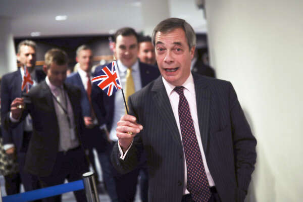 British European Parliament member Nigel Farage leaves the hemicycle after addressing European lawmakers during the plenary session at the European Parliament in Brussels, Wednesday, Jan. 29, 2020. The U.K. is due to leave the EU on Friday, Jan. 31, 2020, the first nation in the bloc to do so. (AP Photo/Francisco Seco)
