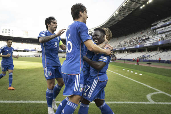 Italy’s Wilfried Gnonto, celebrates with his teammates after scoring his side’s second goal during the Under 21 European Championships soccer match between Switzerland and Italy, in the Cluj Arena in Cluj-Napoca, Romania, Sunday June 25, 2023. (Georgios Kefalas/Keystone via AP)