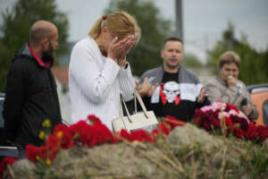 A woman reacts at an informal memorial next to the former ‘PMC Wagner Centre’ in St. Petersburg, Russia, Thursday, Aug. 24, 2023. Russian mercenary leader Yevgeny Prigozhin, the founder of the Wagner Group, reportedly died when a private jet he was said to be on crashed on Aug. 23, 2023, killing all 10 people on board. (AP Photo/Dmitri Lovetsky)