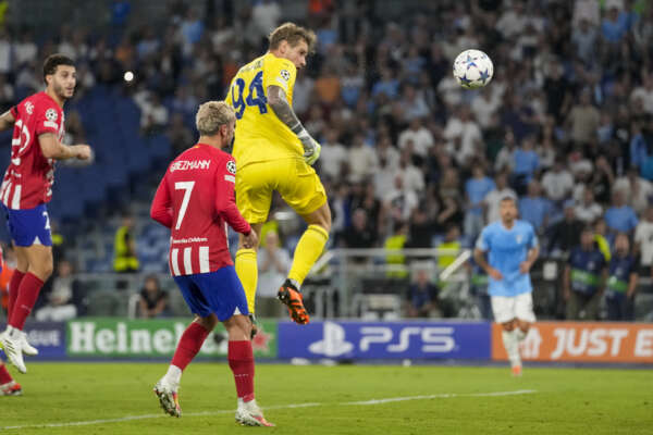 Lazio’s goalkeeper Ivan Provedel, top, scores his side’s opening goal during a Champions League group E soccer match between Lazio and Atletico Madrid, at Rome’s Olympic Stadium, Tuesday, Sept. 19, 2023. (AP Photo/Andrew Medichini)