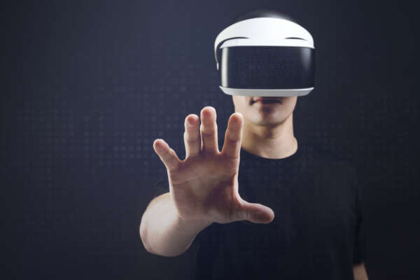 Man with VR headset touching invisible object