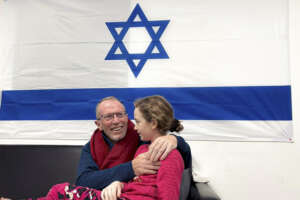 In this photo provided by the Israeli Army, Emily Hand, a released hostage, reunites with her father Sunday, Nov. 26, 2023, in Israel. The tense cease-fire between Israel and Hamas appeared to be back on track after the release of a second group of militant-held hostages and Palestinian prisoners. (The Israeli Army via AP)