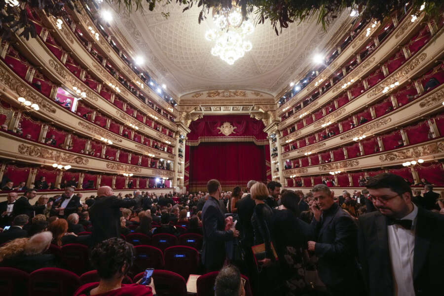 Spectators arrive to attend La Scala opera house’s gala season opener, Giuseppe Verdi’s opera ‘Don Carlo’ at the Milan La Scala theater, Italy, Thursday Dec. 7, 2023. The season-opener Thursday, held each year on the Milan feast day St. Ambrose, is considered one of the highlights of the European cultural calendar. (AP Photo/Luca Bruno)