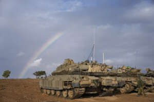 Israeli tanks are parked at an army staging area near Israel’s border with Gaza, southern Israel, Monday, Nov. 27, 2023. on the fourth day of a temporary cease-fire between Israel and Hamas. (AP Photo/Ohad Zwigenberg)