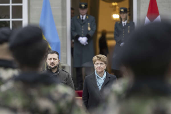Swiss Federal President Viola Amherd, right, and her guest, Volodymyr Zelenskyy, left, President of Ukraine, attend a military welcome ceremony in Kehrsatz near Bern, Switzerland, Monday, Jan. 15, 2024. Zelenskyy will attend the World Economic Forum in Davos starting Tuesday. (Alessandro della Valle/Keystone via AP, Pool)