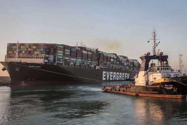 In this photo released by Suez Canal Authority, the Ever Given, a Panama-flagged cargo ship, is pulled by one of the Suez Canal tugboats, in the Suez Canal, Egypt, Monday, March 29, 2021. Engineers on Monday “partially refloated ” the colossal container ship that continues to block traffic through the Suez Canal, authorities said, without providing further details about when the vessel would be set free. (Suez Canal Authority via AP)