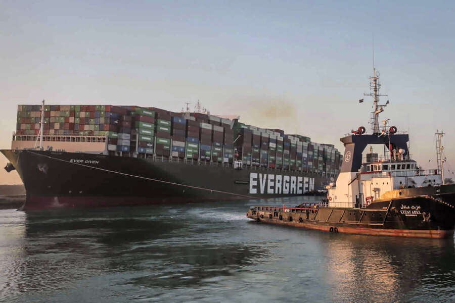 In this photo released by Suez Canal Authority, the Ever Given, a Panama-flagged cargo ship, is pulled by one of the Suez Canal tugboats, in the Suez Canal, Egypt, Monday, March 29, 2021. Engineers on Monday “partially refloated ” the colossal container ship that continues to block traffic through the Suez Canal, authorities said, without providing further details about when the vessel would be set free. (Suez Canal Authority via AP)