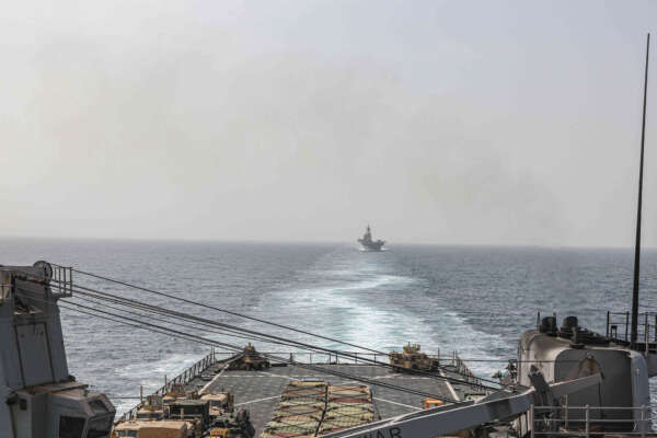 In this image provided by the U.S. Navy, the amphibious dock landing ship USS Carter Hall and amphibious assault ship USS Bataan transit the Bab al-Mandeb strait on Aug. 9, 2023.  The top commander of U.S. naval forces in the Middle East says Yemen’s Houthi rebels are showing no signs of ending their “reckless” attacks on commercial ships in the Red Sea. But Vice Adm. Brad Cooper said in an Associated Press interview on Saturday that more nations are joining the international maritime mission to protect vessels in the vital waterway and trade traffic is beginning to pick up. (Mass Communications Spc. 2nd Class Moises Sandoval/U.S. Navy via AP)