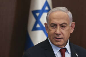 FILE – Israeli Prime Minister Benjamin Netanyahu attends the weekly cabinet meeting at the Prime Minister’s office in Jerusalem, Dec. 10, 2023. A law that would make it harder to remove Netanyahu from office must go into effect only after the next parliamentary elections, the country’s Supreme Court ruled Wednesday, Jan. 3, 2024, saying the legislation was clearly crafted for personal reasons. (Ronen Zvulun/Pool Photo via AP, File)