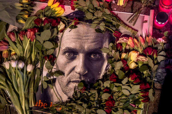 Flowers and a photo of Russian opposition leader Alexei Navalny are placed near the Russian consulate in Frankfurt, Germany, Saturday, Feb. 17, 2024. Navalny, who crusaded against official corruption and staged massive anti-Kremlin protests as President Vladimir Putin’s fiercest foe, died Friday in the Arctic penal colony where he was serving a 19-year sentence, Russia’s prison agency said. He was 47. (AP Photo/Michael Probst)