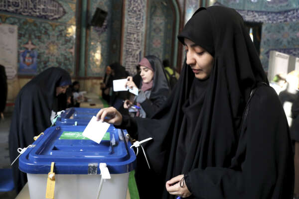An Iranian woman casts her vote at a polling station in Tehran, Iran, Friday, Feb. 21, 2020. Iranians began voting for a new parliament Friday, with turnout seen as a key measure of support for Iran’s leadership as sanctions weigh on the economy and isolate the country diplomatically. (AP Photo/Ebrahim Noroozi) An Iranian woman casts her vote at a polling station in Tehran, Iran, Friday, Feb. 21, 2020. Iranians began voting for a new parliament Friday, with turnout seen as a key measure of support for Iran’s leadership as sanctions weigh on the economy and isolate the country diplomatically. (AP Photo/Ebrahim Noroozi)