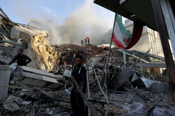 Emergency services work at a destroyed building hit by an air strike in Damascus, Syria, Monday, April 1, 2024. An Israeli airstrike has destroyed the consular section of Iran’s embassy in Damascus, killing or wounding everyone inside, Syrian state media said Monday. (AP Photo/Omar Sanadiki)