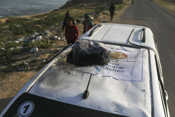 Palestinians inspect a vehicle with the logo of the World Central Kitchen wrecked by an Israeli airstrike in Deir al Balah, Gaza Strip, Tuesday, April 2, 2024. A series of airstrikes killed seven aid workers from the international charity, leading it to suspend delivery Tuesday of vital food aid to Gaza. (AP Photo/Ismael Abu Dayyah) Palestinians inspect a vehicle with the logo of the World Central Kitchen wrecked by an Israeli airstrike in Deir al Balah, Gaza Strip, Tuesday, April 2, 2024. A series of airstrikes killed seven aid workers from the international charity, leading it to suspend delivery Tuesday of vital food aid to Gaza. (AP Photo/Ismael Abu Dayyah)
